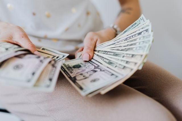 Person reviewing expenses and creating a budget to stop overspending